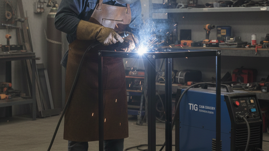 a man welding the frame of the stock rack in the work shop to reinfore the rack